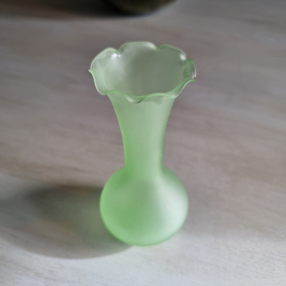 Vintage frosted green glass bud vase with ruffled rim and matte finish.