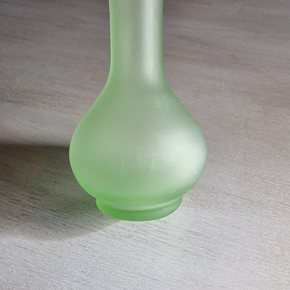 Vintage frosted green glass bud vase with ruffled rim and matte finish.