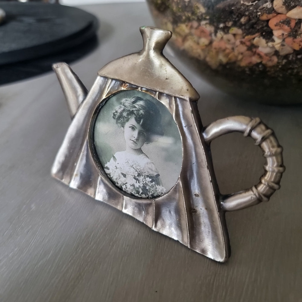 Vintage pewter teapot-shaped photo frame with round window