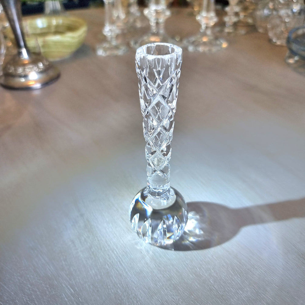Crystal bud vase with lattice-cut stem and rounded faceted base.