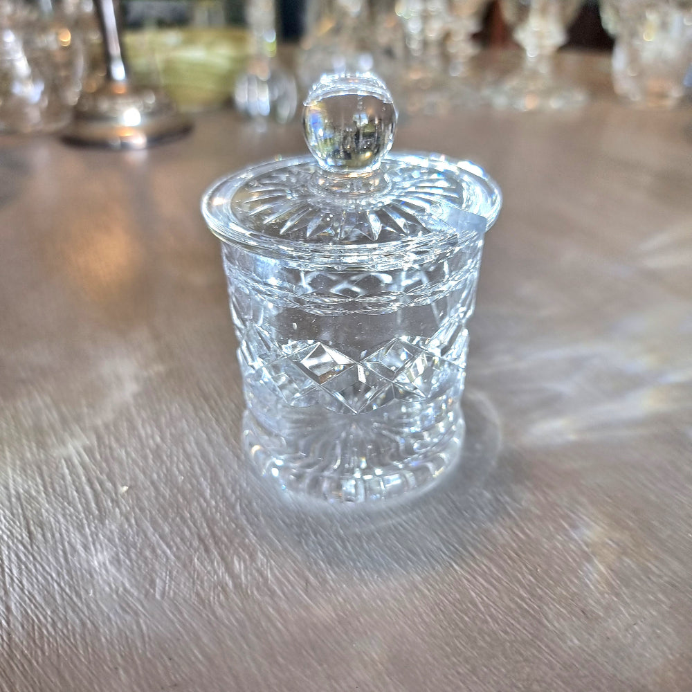 Small crystal jam jar with starburst lid and faceted cut-glass pattern.
