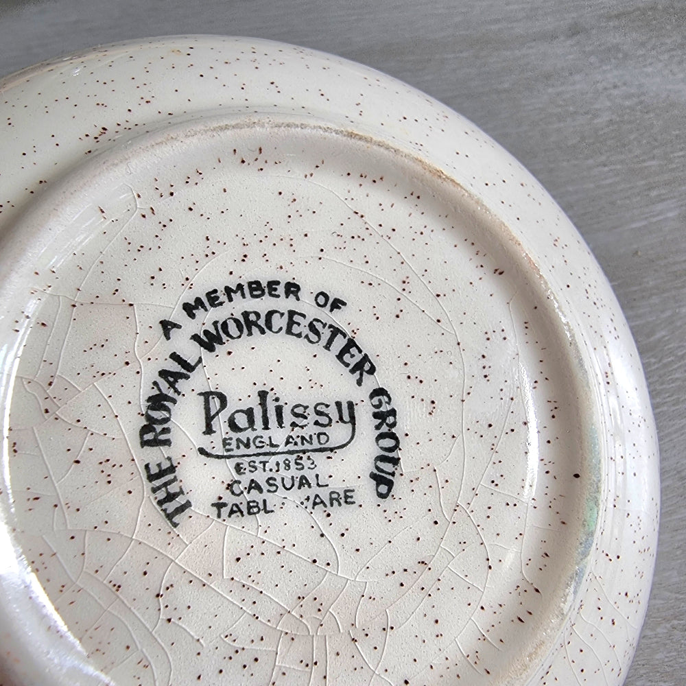 Vintage Palissy England dish with yellow and orange floral design and speckled glaze.