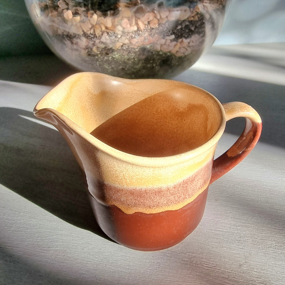 Vintage Crown Lynn cream jug marked 6068 with layered earthy terracotta and caramel glaze.