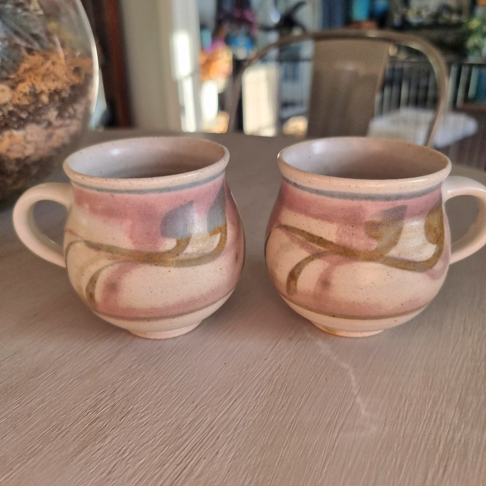 Pair of Michael Macmillan stoneware cups with blush pink, cream and gold swirl glaze