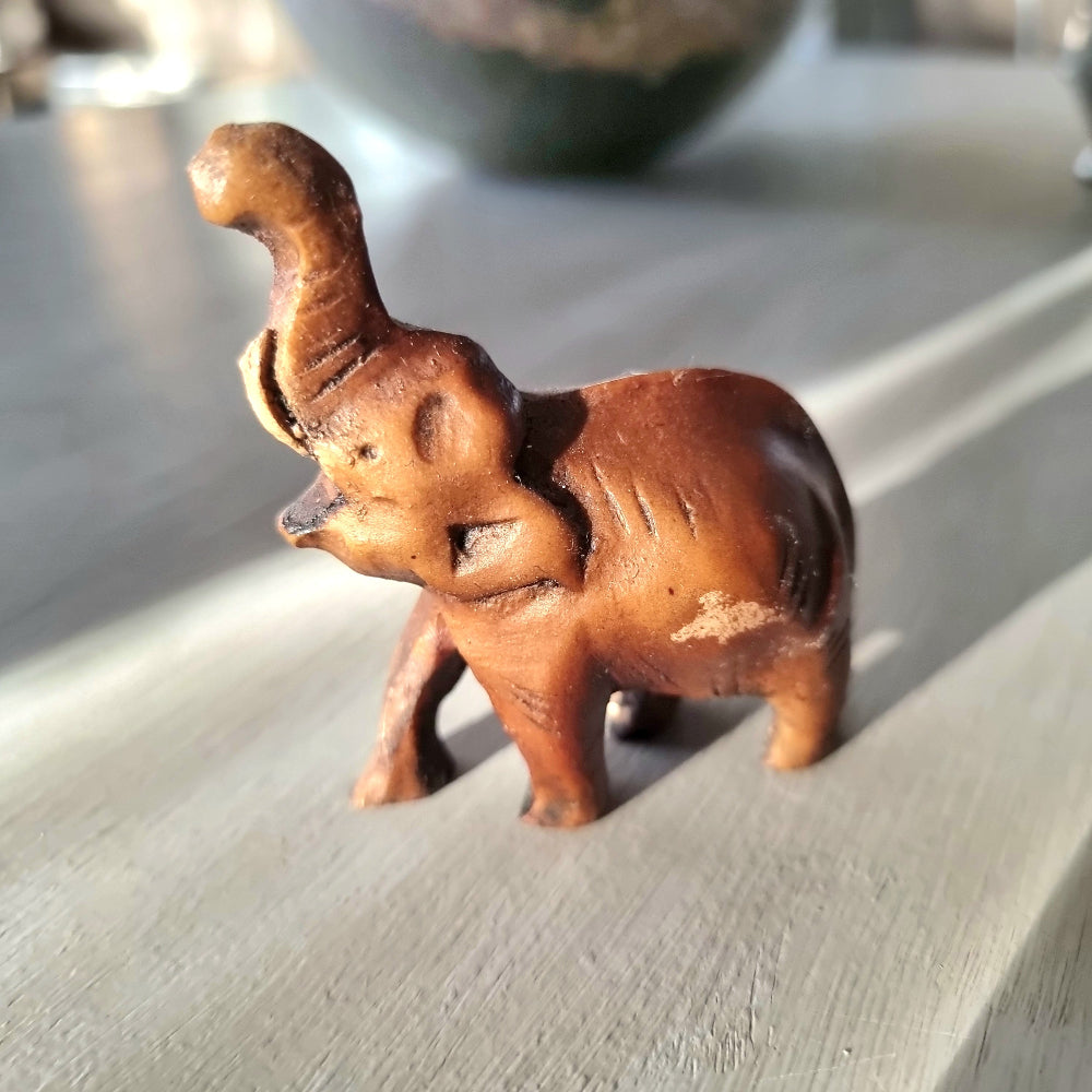 Miniature hand-carved wooden elephant figurine