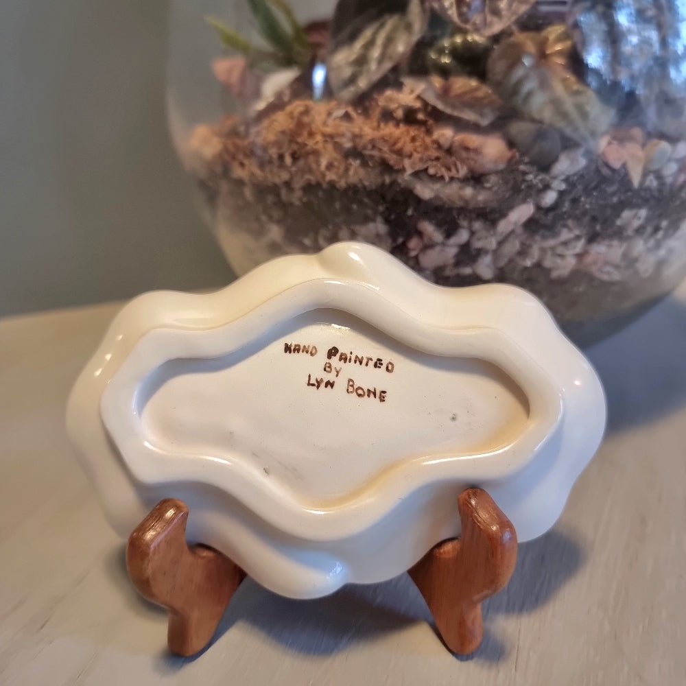 Vintage hand painted ceramic trinket dish by Lyn Bone with yellow rose and floral design on wavy edged oval dish