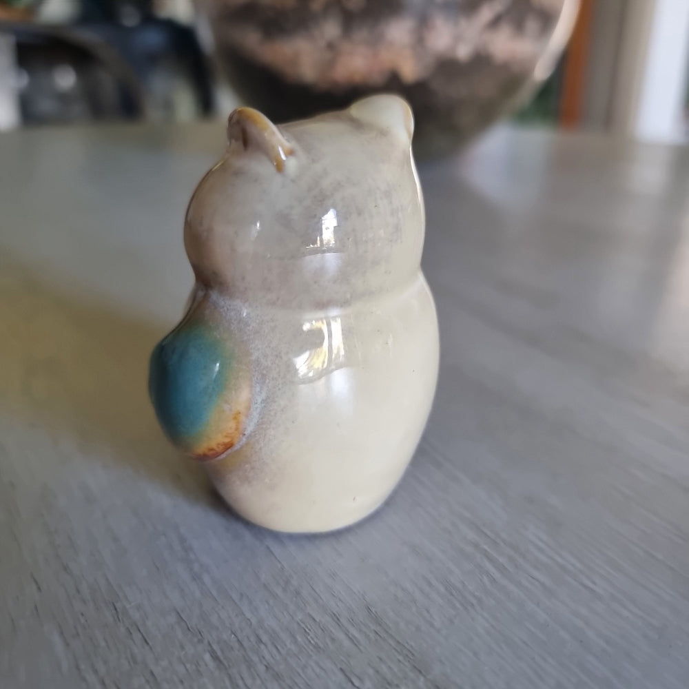 Small ceramic owl figurine with a teal drip glaze