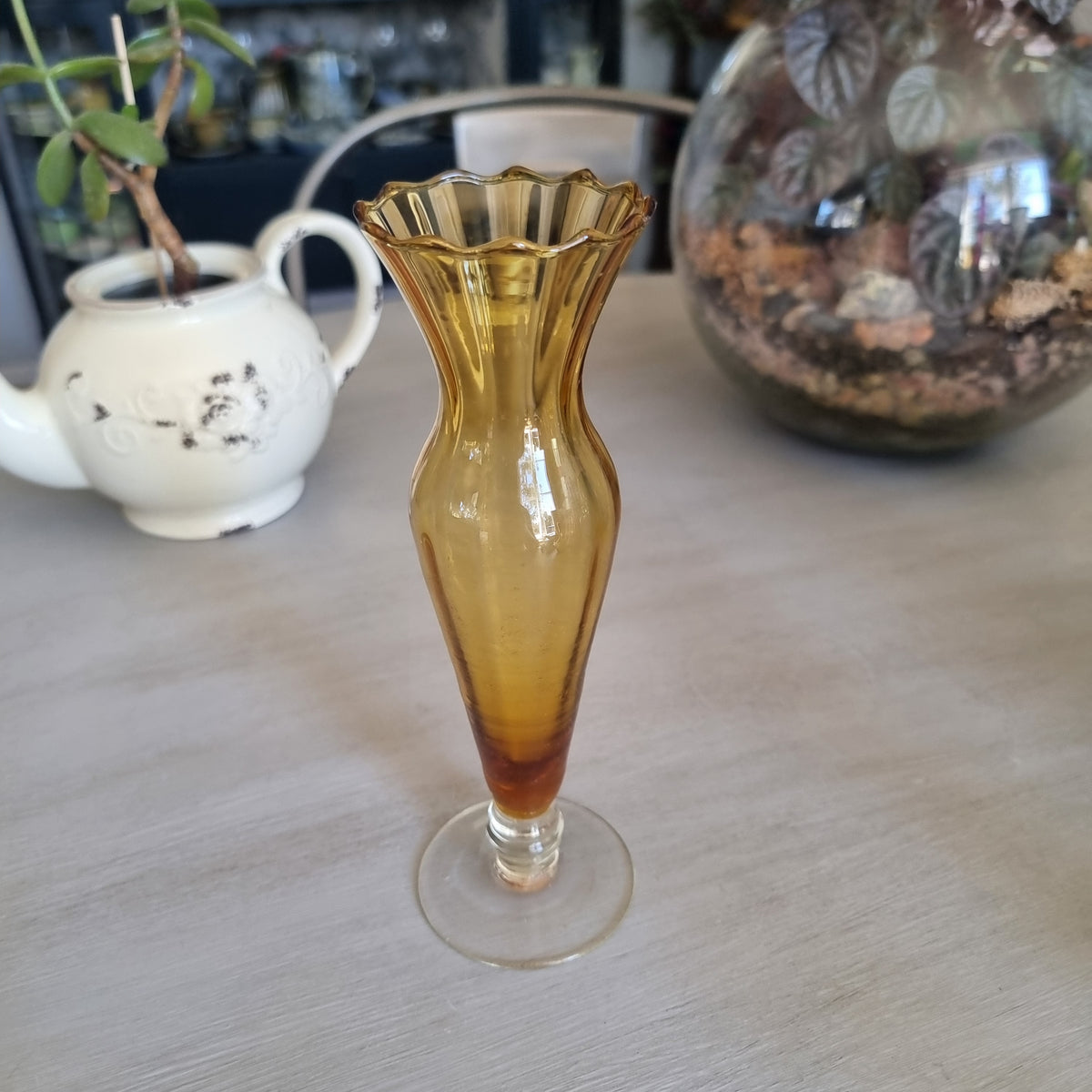 Vintage amber glass bud vase with a scalloped rim, ribbed body and clear glass foot