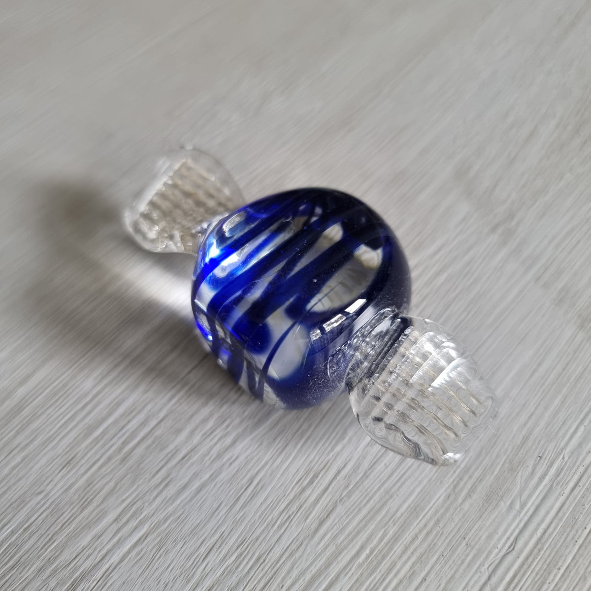 Blue and clear glass wrapped lolly ornament with cobalt swirls