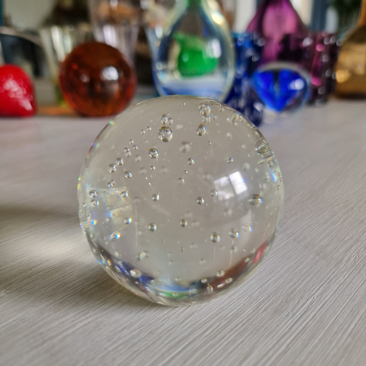 Clear glass paperweight with suspended bubbles