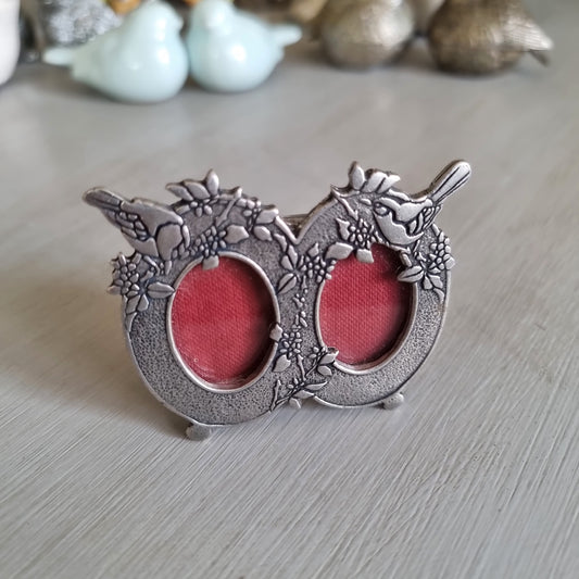Small Mack English pewter double oval frame with flowers, perched birds and red velvet backing