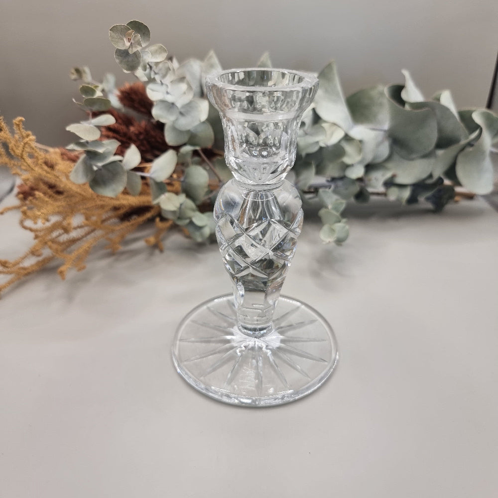 Clear cut crystal taper candle holder with cross-hatched stem and faceted round base.