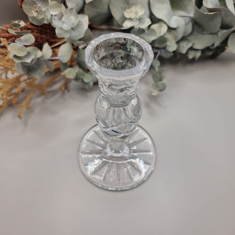 Clear cut crystal taper candle holder with cross-hatched stem and faceted round base.