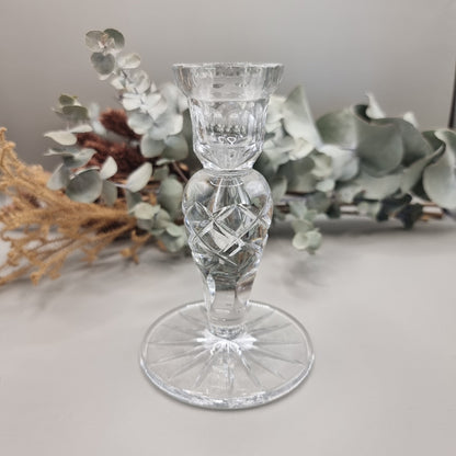 Clear cut crystal taper candle holder with cross-hatched stem and faceted round base.