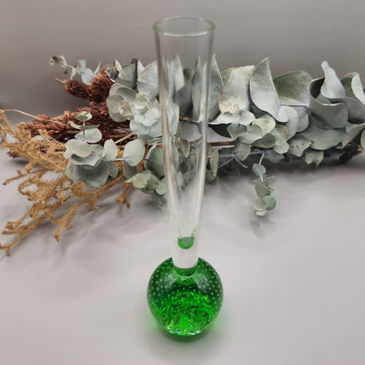 Tall clear glass bud vase with vibrant green bubble-filled base.