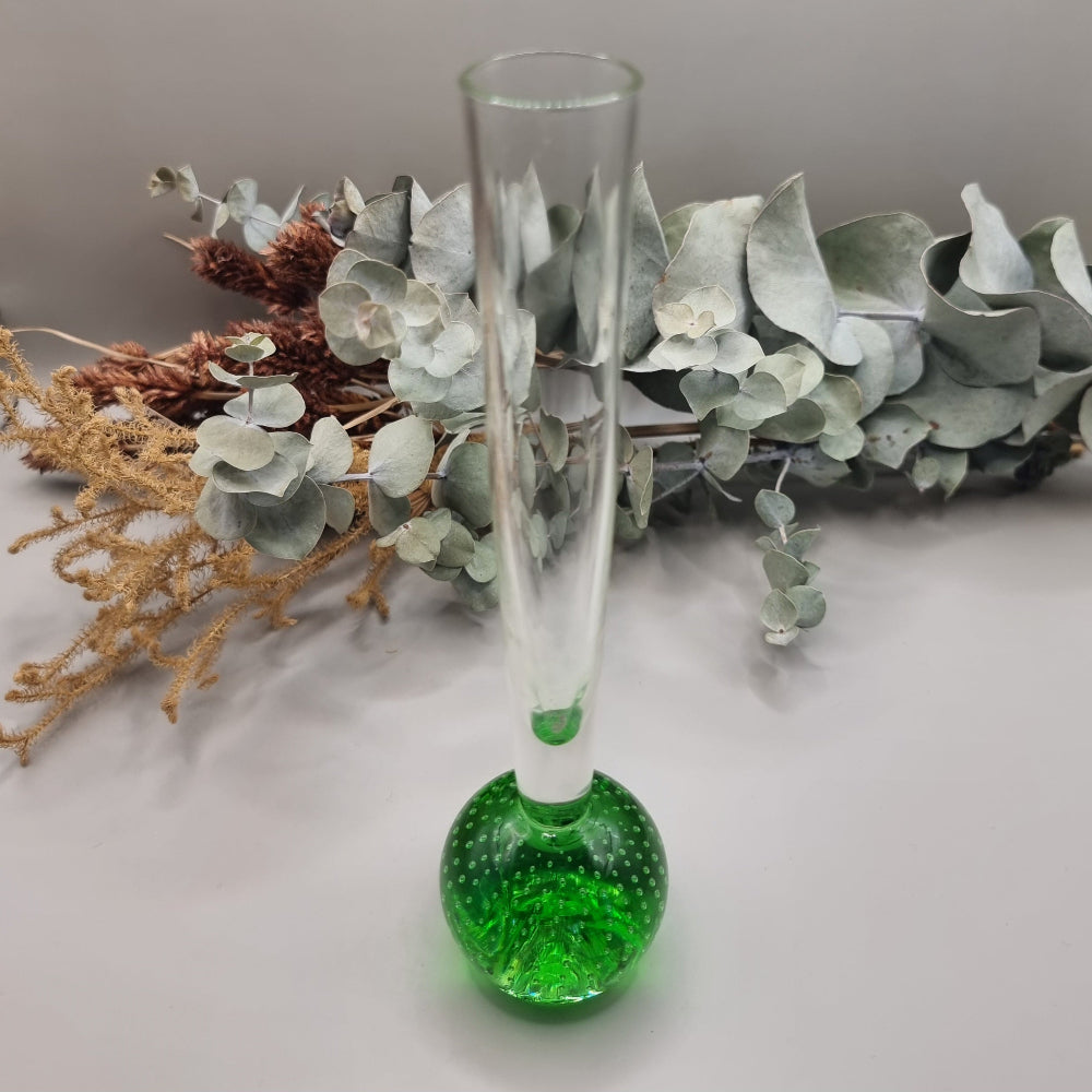 Tall clear glass bud vase with vibrant green bubble-filled base.
