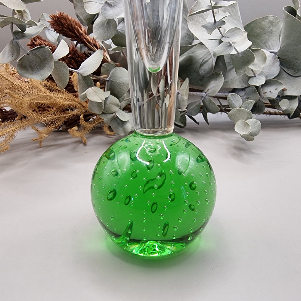 Tall clear glass bud vase with vibrant green bubble-filled base.