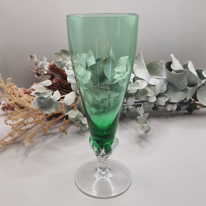 Tall green champagne flute with twisted clear stem and flared base