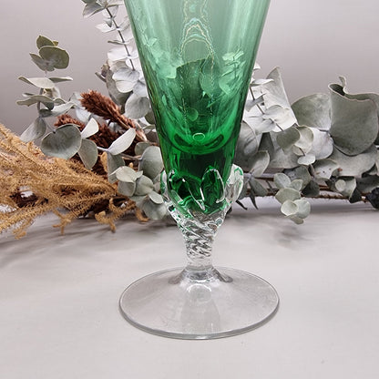 Tall green champagne flute with twisted clear stem and flared base
