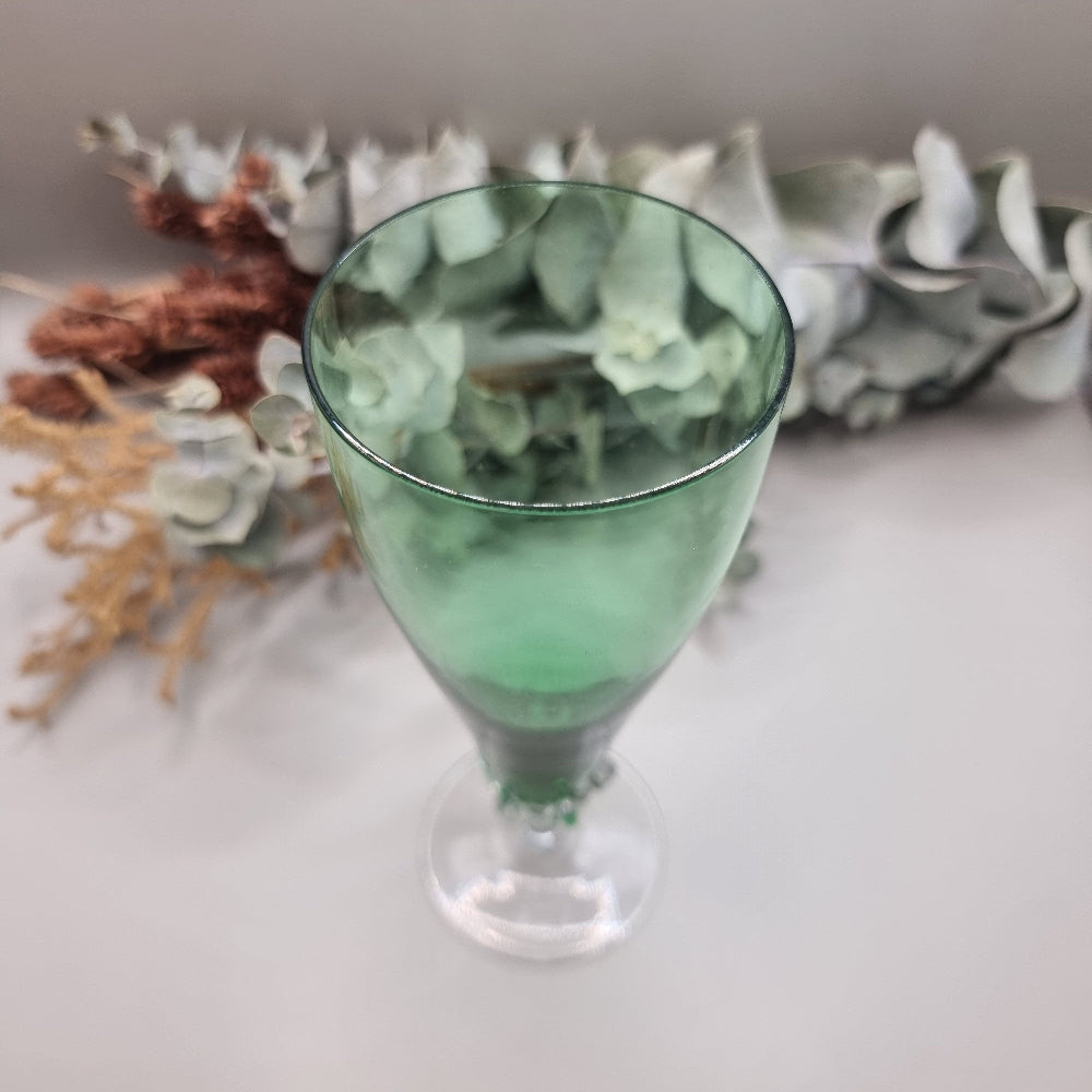 Tall green champagne flute with twisted clear stem and flared base