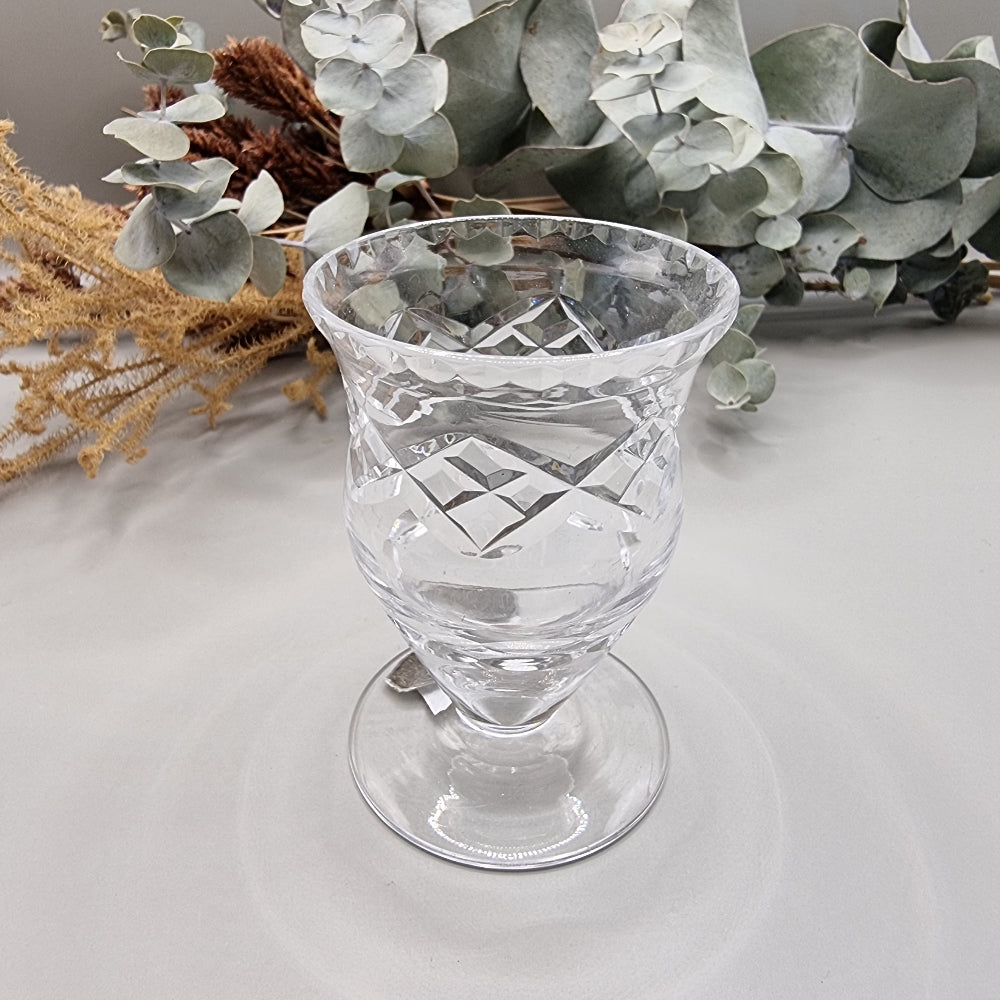 Harbridge cut crystal vase with flared rim and diamond pattern on a pedestal base.