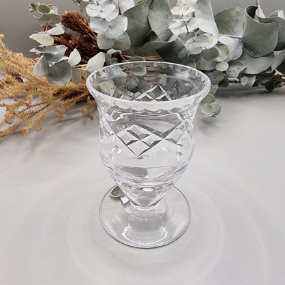 Harbridge cut crystal vase with flared rim and diamond pattern on a pedestal base.