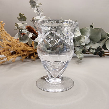 Harbridge cut crystal vase with flared rim and diamond pattern on a pedestal base.