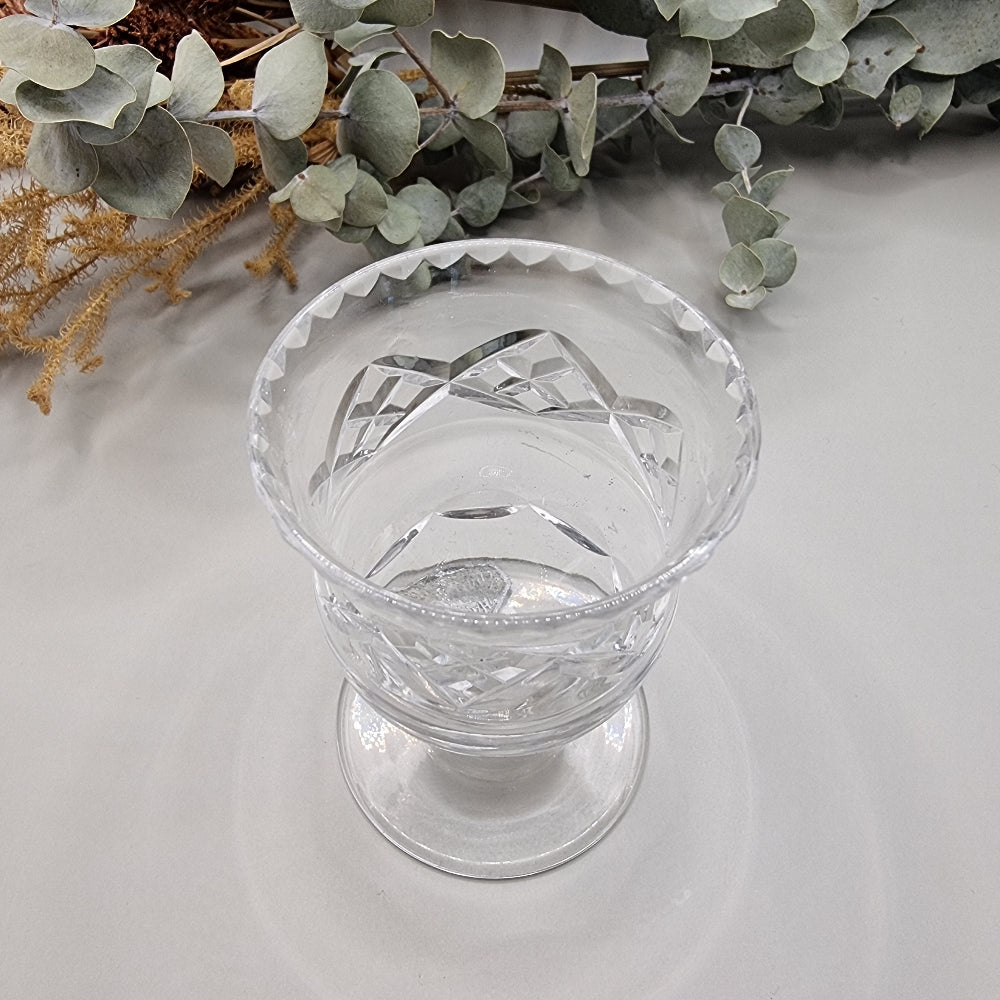 Harbridge cut crystal vase with flared rim and diamond pattern on a pedestal base.