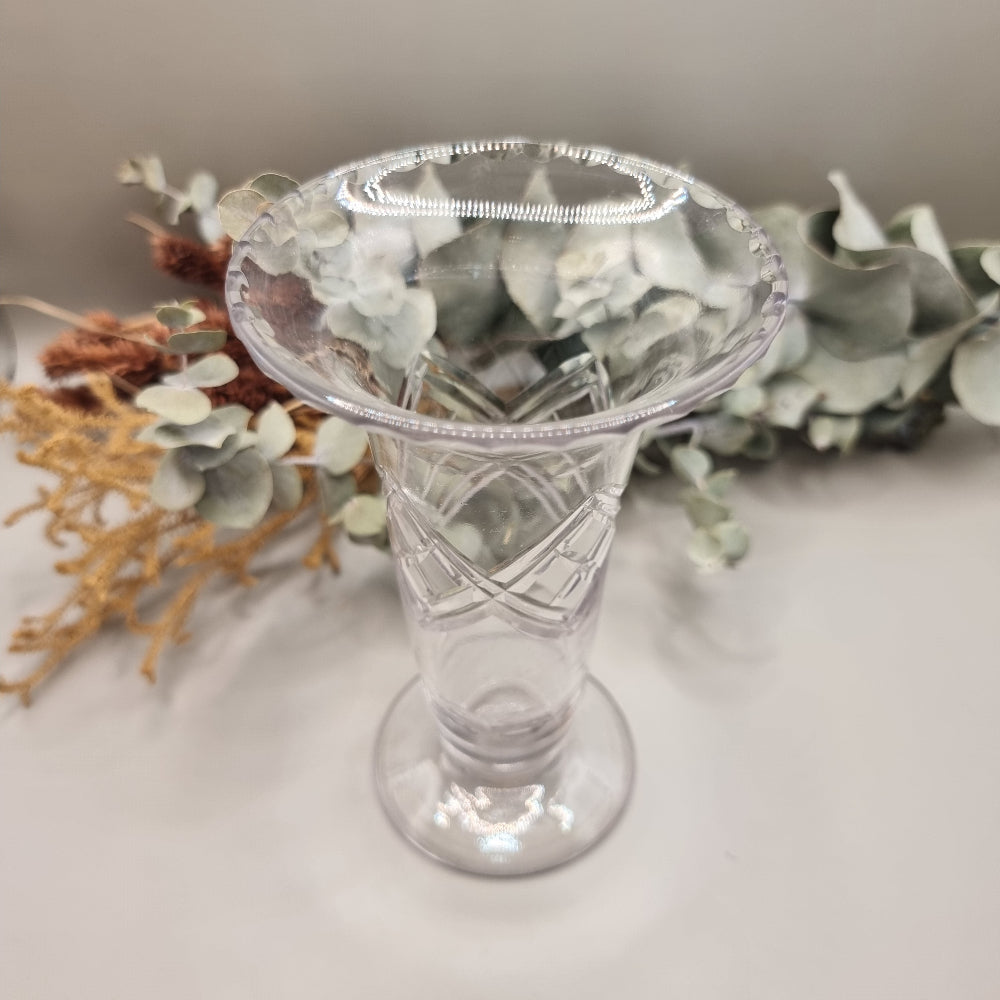 Crystal bud vase with flared rim and crosshatch cut pattern on footed base.