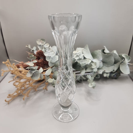 Lead crystal bud vase with fluted top and cut diamond pattern on a footed base.