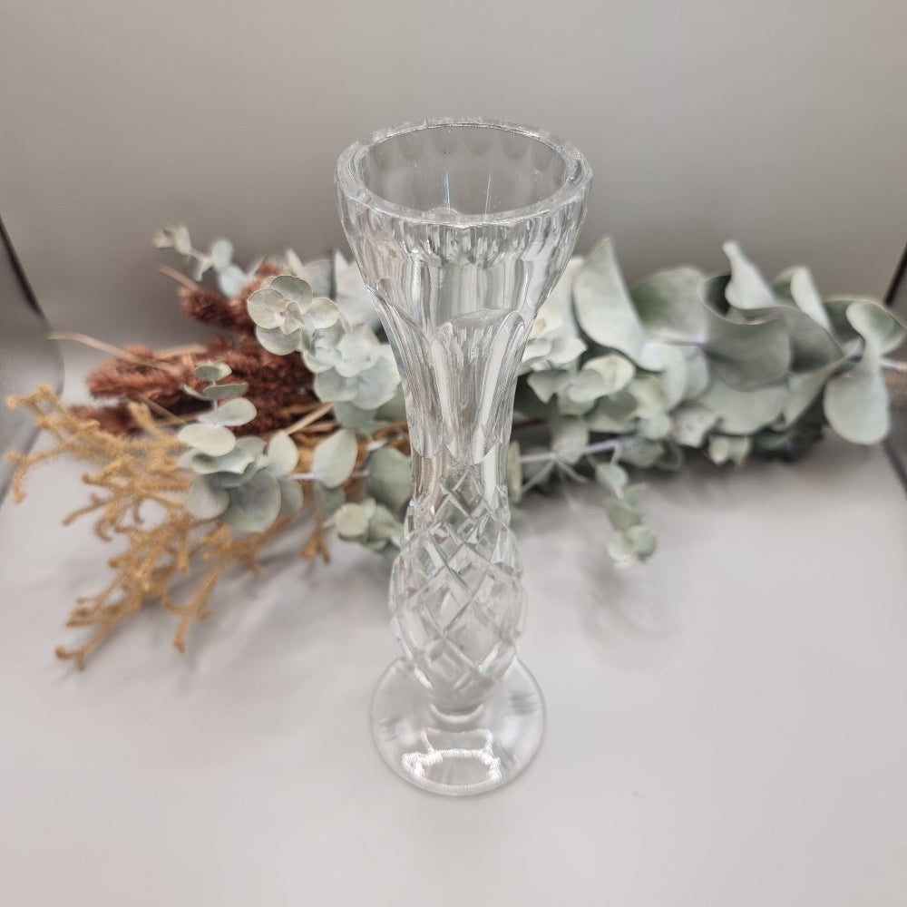 Lead crystal bud vase with fluted top and cut diamond pattern on a footed base.