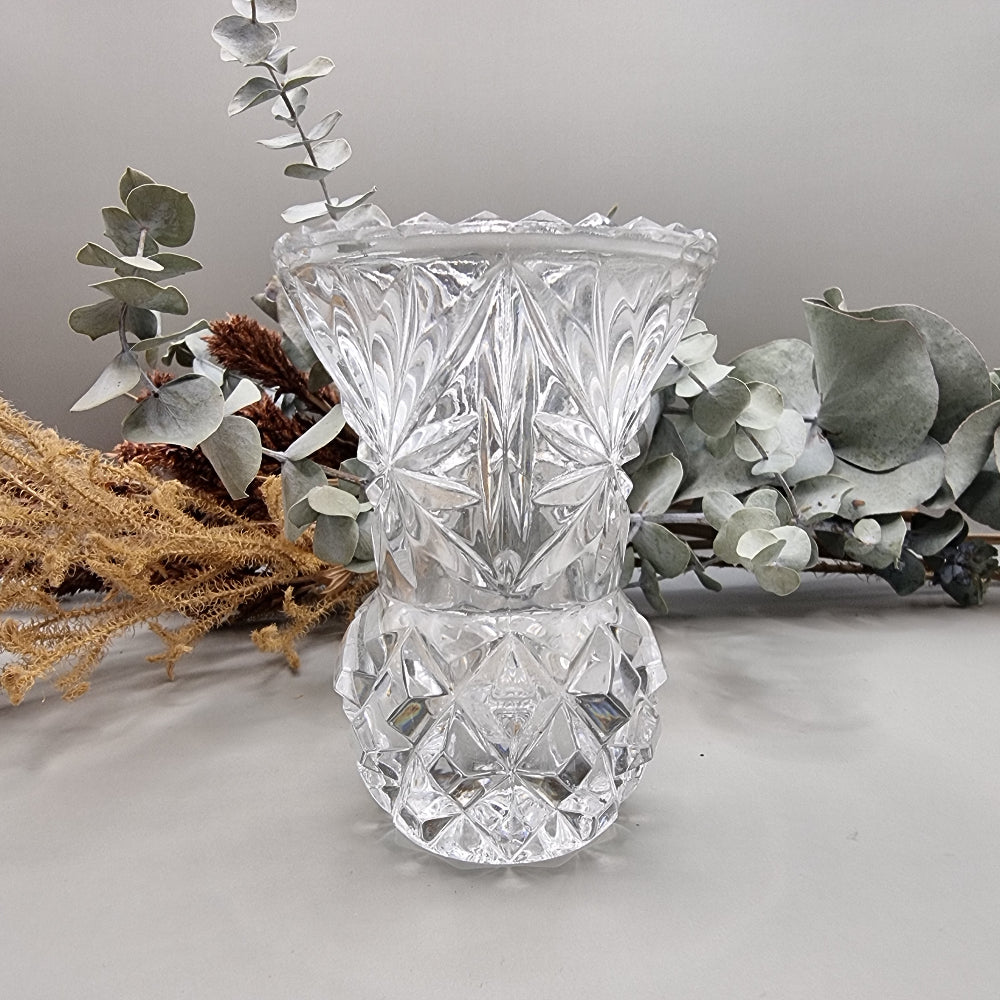 Vintage cut glass bud vase with starburst pattern and faceted base.
