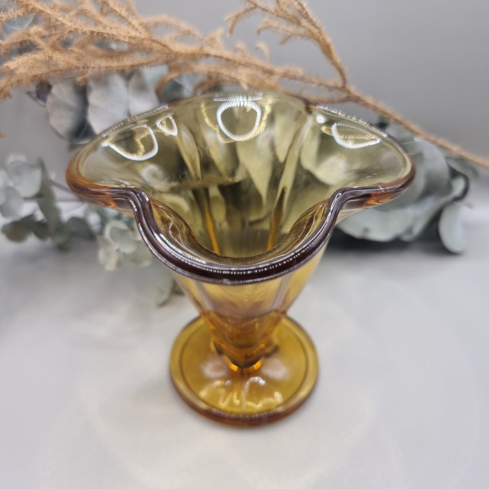 Amber flared glass vase or sundae dish with ribbed sides and footed base.