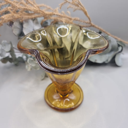Amber flared glass vase or sundae dish with ribbed sides and footed base.