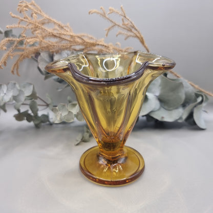 Amber flared glass vase or sundae dish with ribbed sides and footed base.