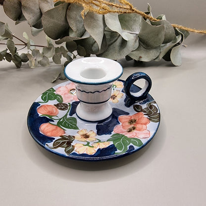 Vintage hand-painted ceramic chamberstick candle holder with pink rose and floral design on navy blue and white glaze