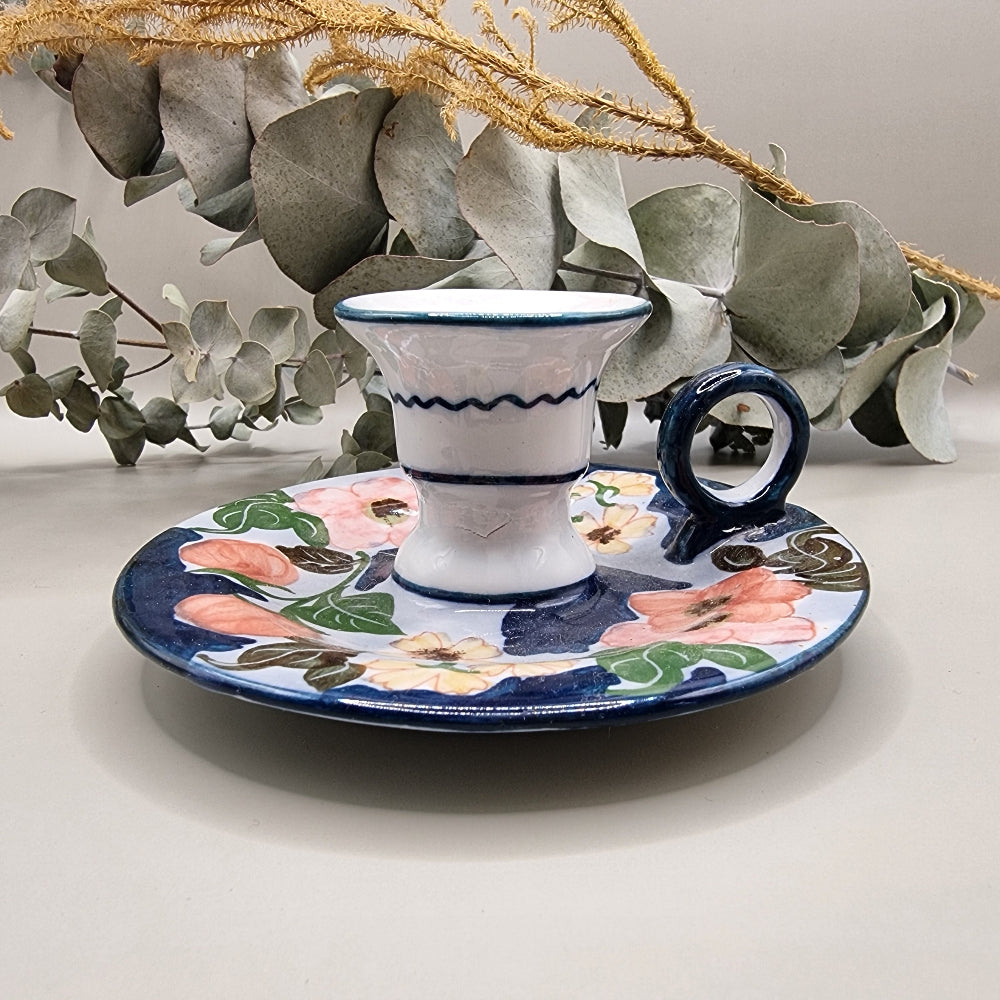 Vintage hand-painted ceramic chamberstick candle holder with pink rose and floral design on navy blue and white glaze