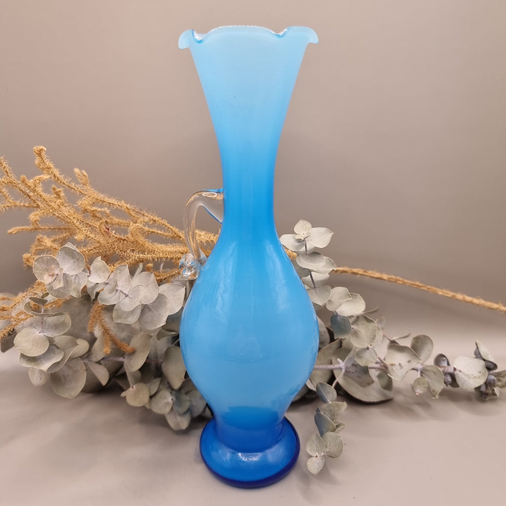 Blue art glass vase with scalloped rim and clear handle, vintage-style ewer shape