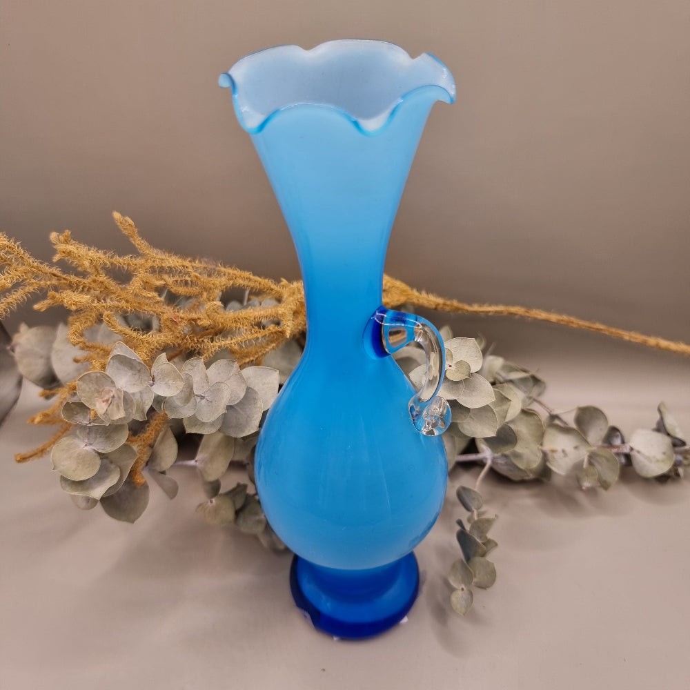 Blue art glass vase with scalloped rim and clear handle, vintage-style ewer shape