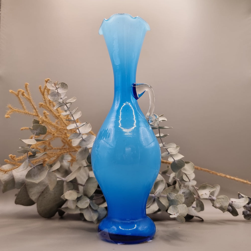 Blue art glass vase with scalloped rim and clear handle, vintage-style ewer shape