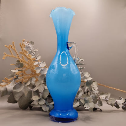 Blue art glass vase with scalloped rim and clear handle, vintage-style ewer shape