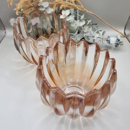 Pair of blush peach scalloped glass tealight holders with petal edge and vertical ridging.