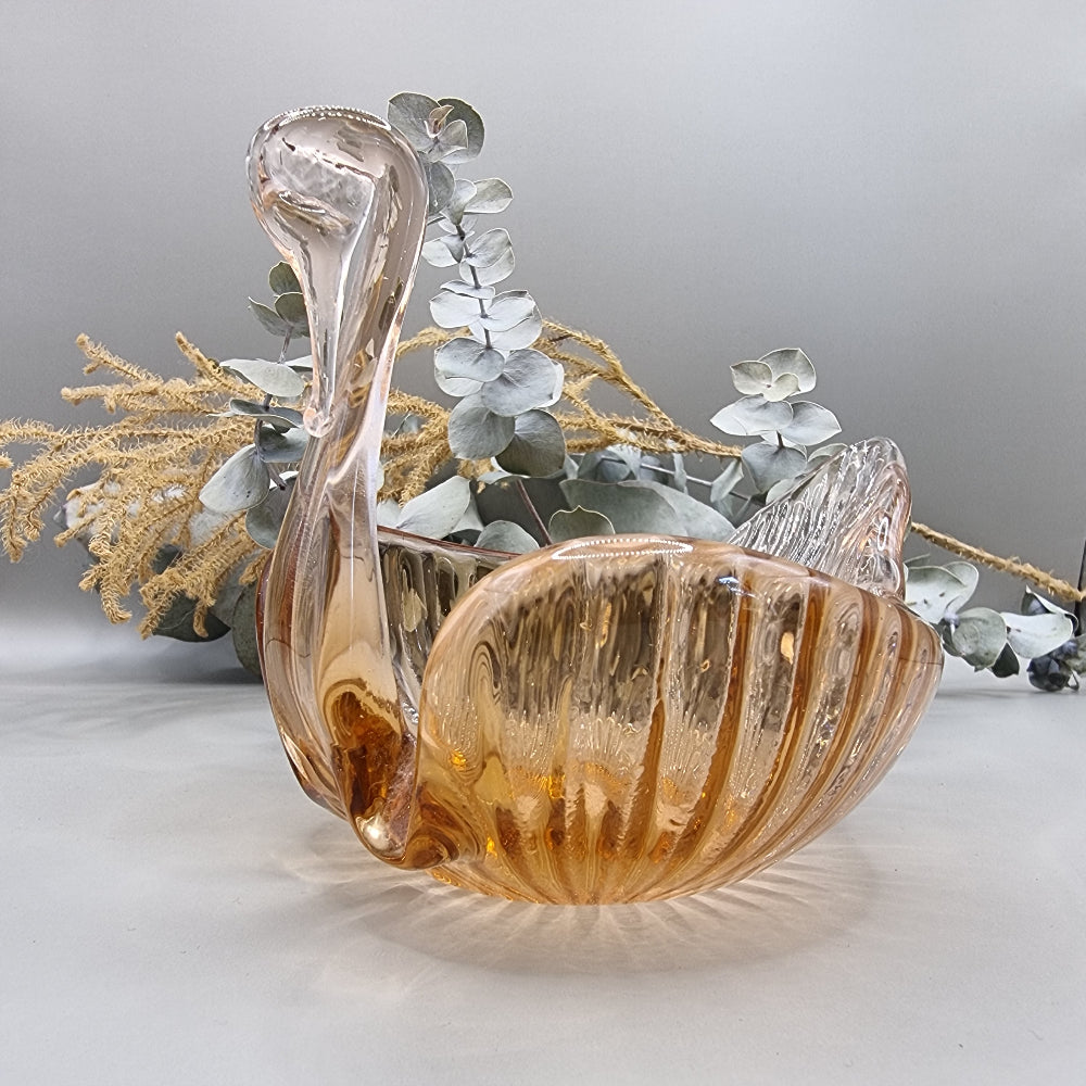 Amber glass swan-shaped trinket dish with ribbed wings and elegant curved neck.