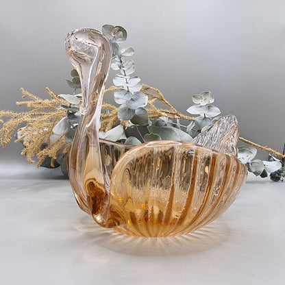 Amber glass swan-shaped trinket dish with ribbed wings and elegant curved neck.