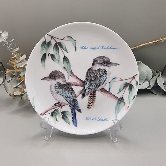 Decorative plate with two Blue-Winged Kookaburras on branches, with botanical detail.