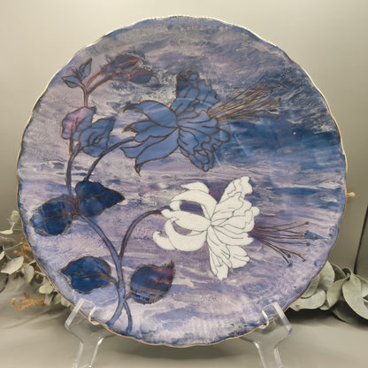 Tirschenreuth Germany floral plate with hand-painted flowers, gold detailing, and purple-blue marbled background.