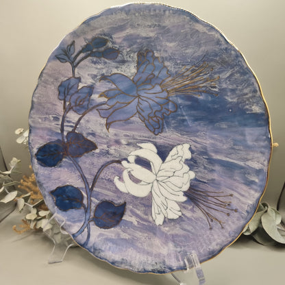 Tirschenreuth Germany floral plate with hand-painted flowers, gold detailing, and purple-blue marbled background.
