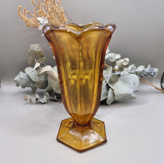 Amber glass with fluted body, scalloped rim and hex base—use as a vase or dessert glass.