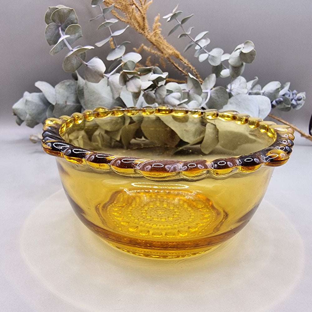 Amber glass bowl with scalloped rim and textured base—perfect for snacks, trinkets or display.
