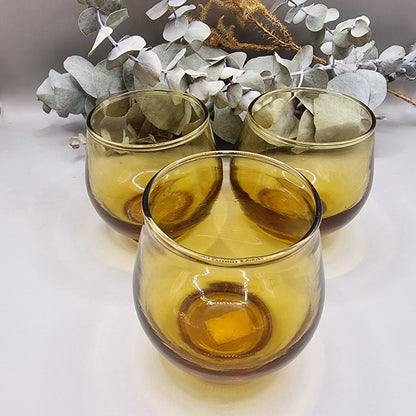 Set of 6 rounded amber glass tumblers, perfect for wine, cocktails, or display.